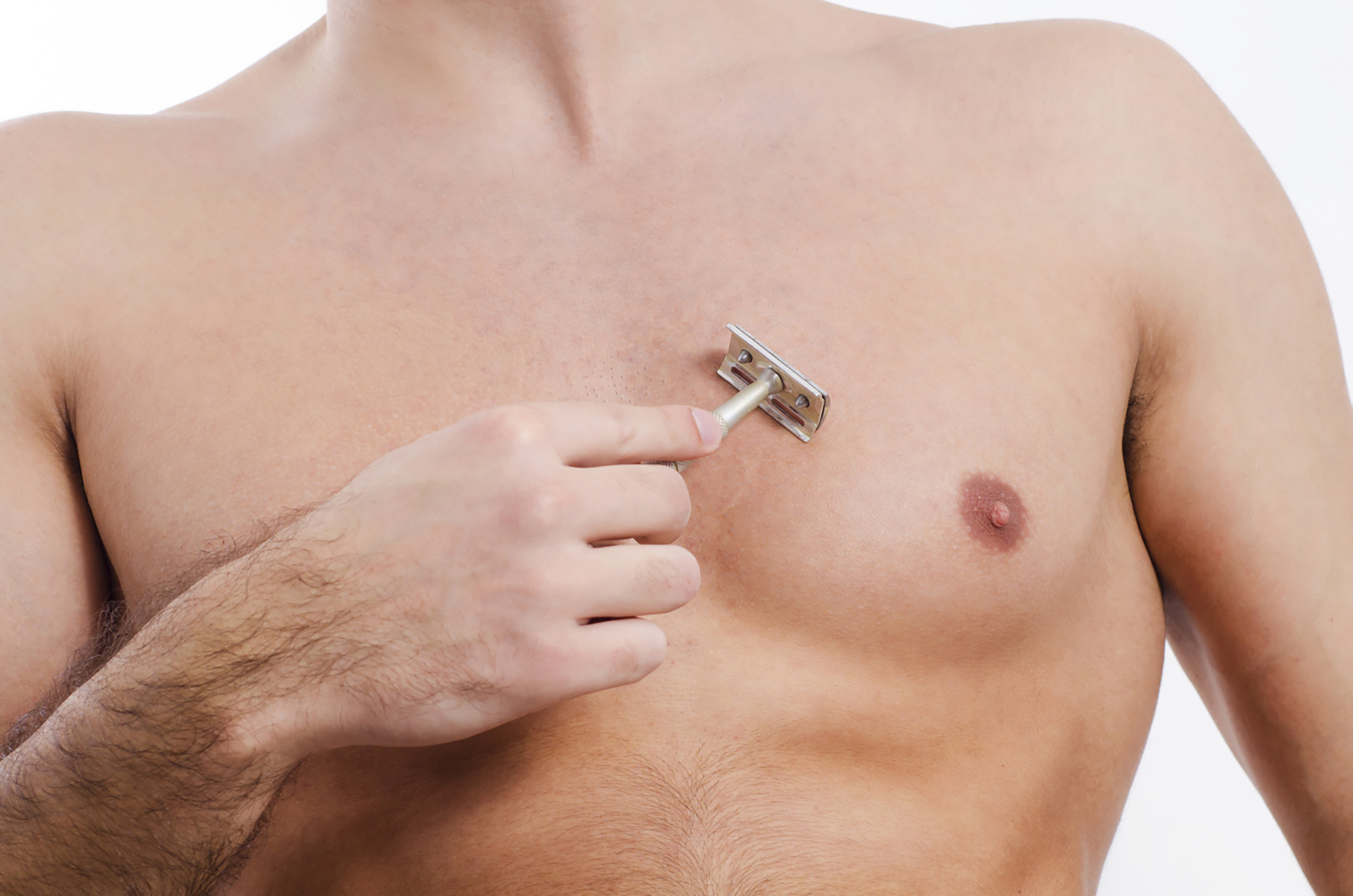 Man shaving his chest with razor, closeup of body