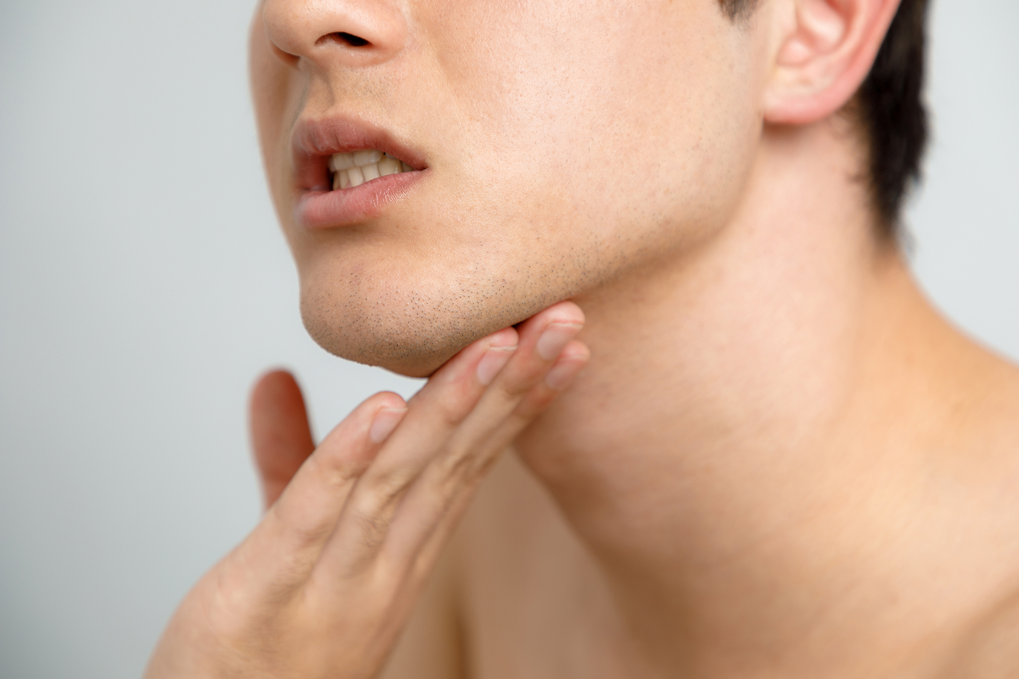 Young man checking his skin, men’s skincare concept, acne treatm