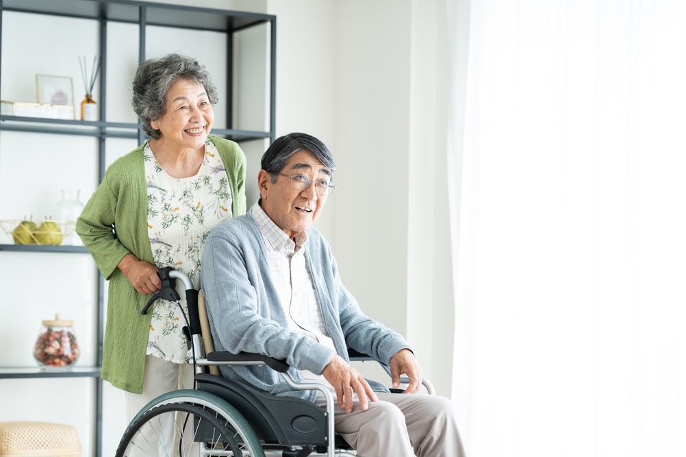 Japanese,Couple,Caring,For,A,Wheelchair-bound,Senior,Citizen,At,Home