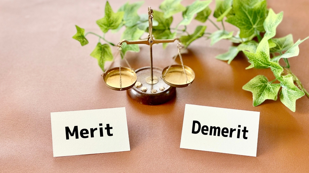 Libra,And,Two,Cards,With,Merit,And,Demerit,Letters_brown,Background